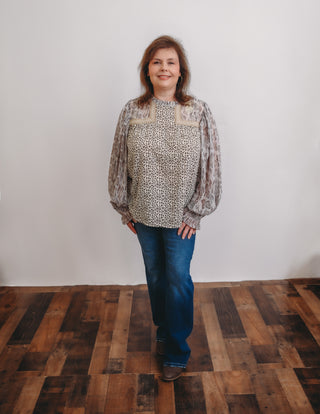 Effortlessly elevate your wardrobe with our Animal Print Blouse. This versatile piece features a button closure at the back of the neck for a secure fit, puffy sleeves with stretch at the wrist for added comfort, and intricate embroidery detail at the neck and chest for a touch of sophistication. Perfect for any occasion, add this blouse to your collection today.